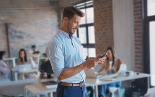 a businessman using his phone on a corporate environment
